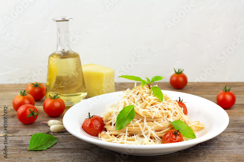 Pasta with tomato sause, cherry tomatoes and basil