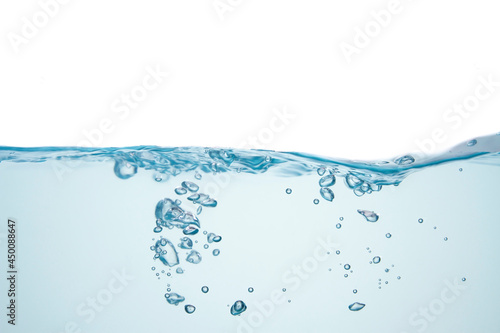 Air bubbles float from the middle of the water to the rippled surface. blue background