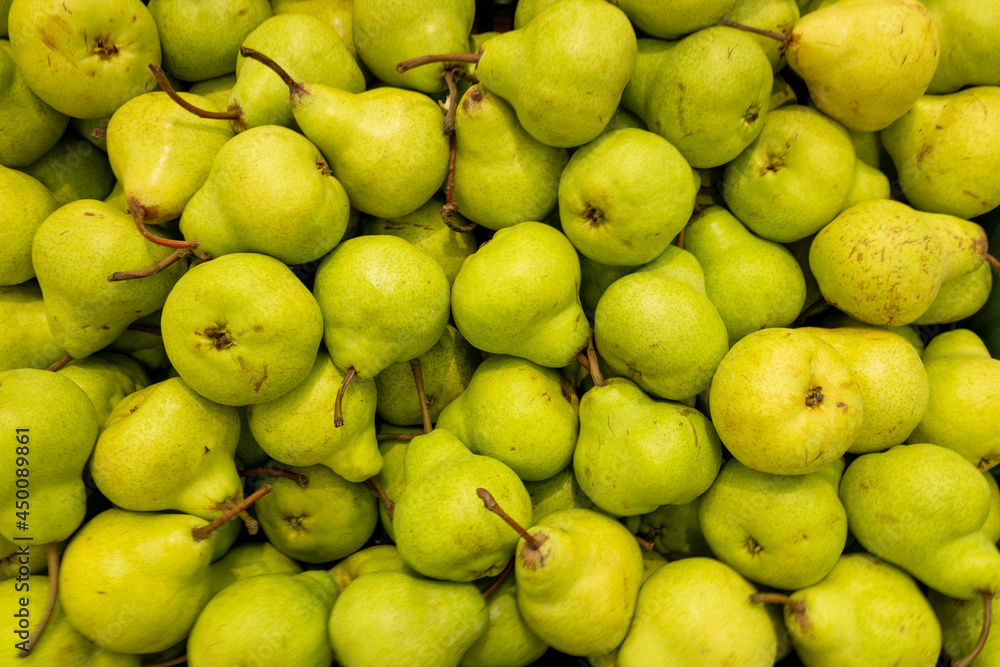 A lot of green ripe pears, background.