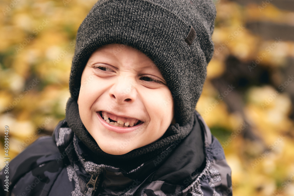 Boy having fun in beautiful park with dry yellow and red leaves. Autumn family walk in forest Boy having fun in beautiful park with dry yellow and red leaves. Autumn family walk in forest