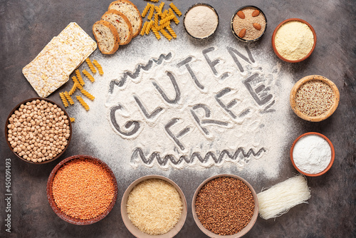 Selection of gluten free food on a brown rustic background. A variety of grains, flours, pasta, and bread gluten-free. Top view, flat lay.