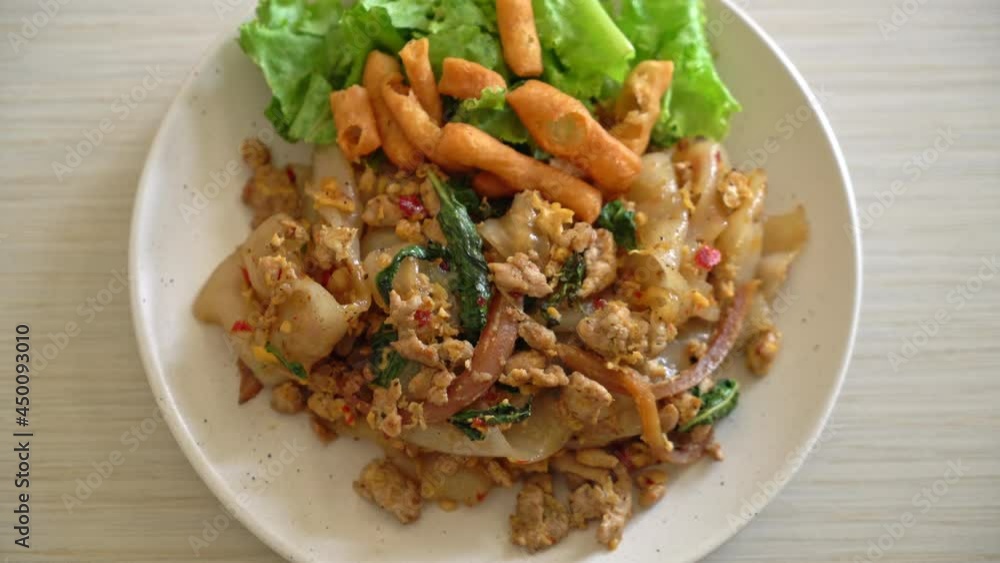 Stir-fried noodle with minced chicken and basil - Asian food style Stir-fried noodle with minced chicken and basil - Asian food style