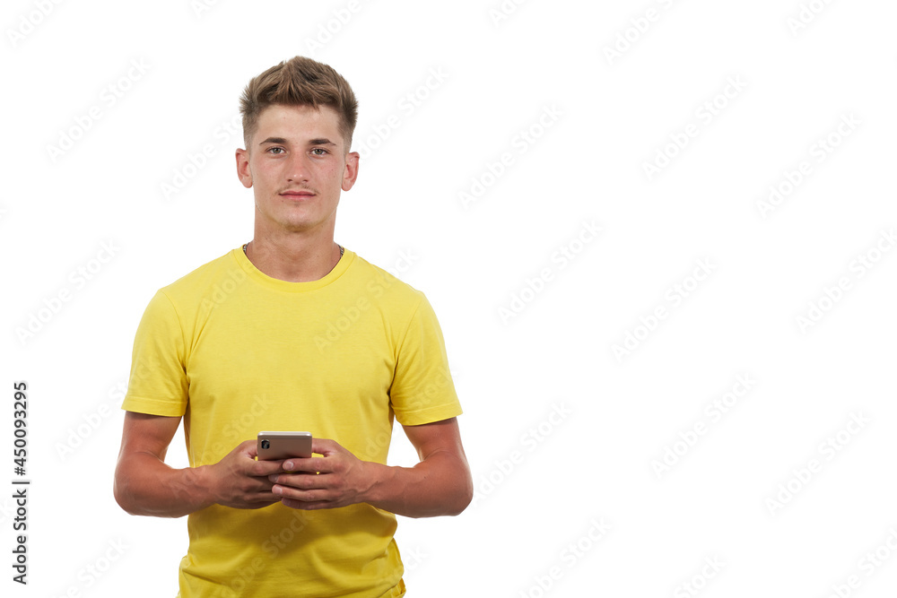 portrait of handsome man dressed casual in yellow t-shirt. Using the smart phone portrait of handsome man dressed casual in yellow t-shirt. Using the smart phone