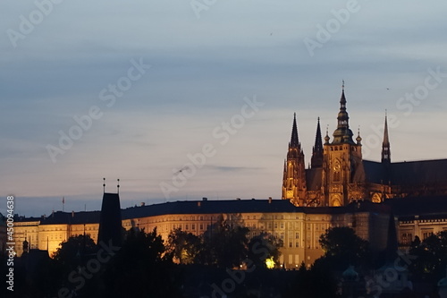 sunset and night view near Charles Bridge, a medieval stone arch bridge that crosses the Vltava (Moldau) river, Prague, Czech Republic