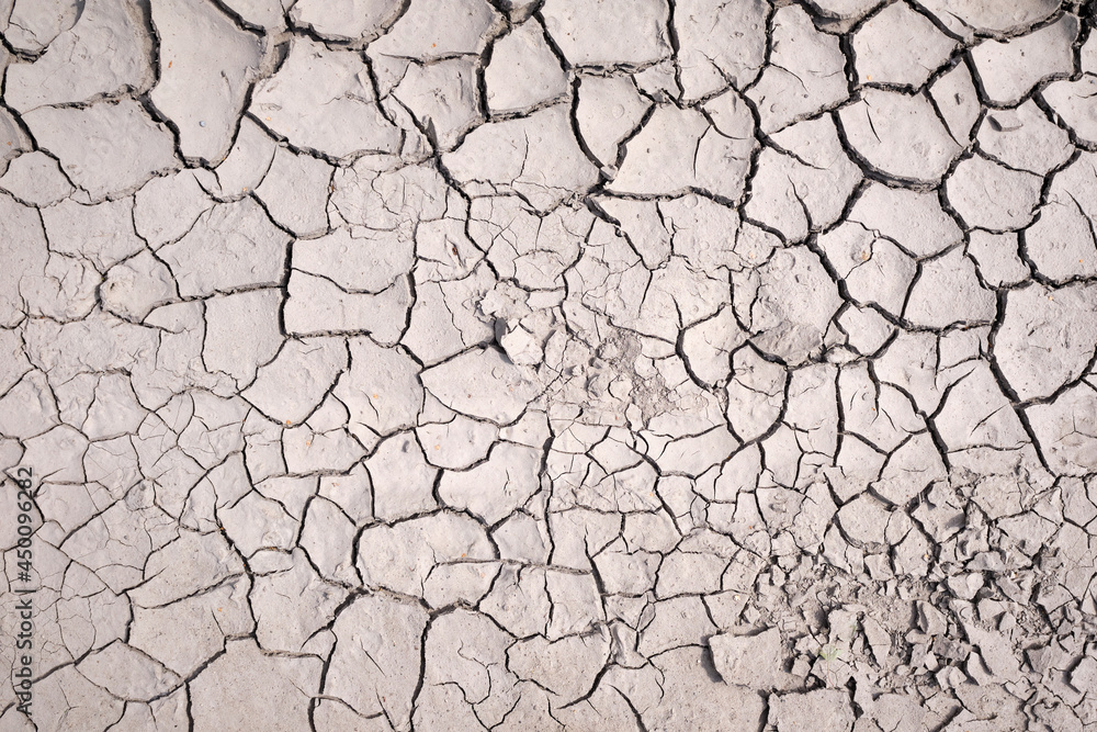 Area of Dried Land Suffering from Drought, ground cracks. texture of grungy dry cracking parched earth... Area of Dried Land Suffering from Drought, ground cracks. texture of grungy dry cracking parched earth...