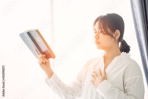 Christian teenage girl holds bible
