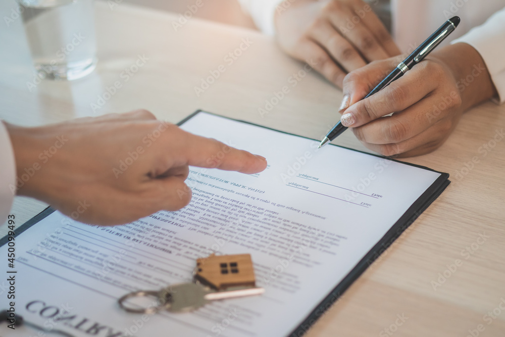 Deal done apartment landlord, banker or realtor man pointing on rent contract renter, tenant or client sign signature on document, paper. Finance,financial of property, estate mortgage or home loan Deal done apartment landlord, banker or realtor man pointing on rent contract renter, tenant or client sign signature on document, paper. Finance,financial of property, estate mortgage or home loan