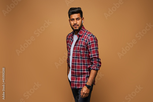 Handsome stylish indian model man in casual close posing on pastel background