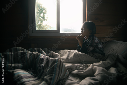 A little girl praying on the bed. Christian prayer concept.