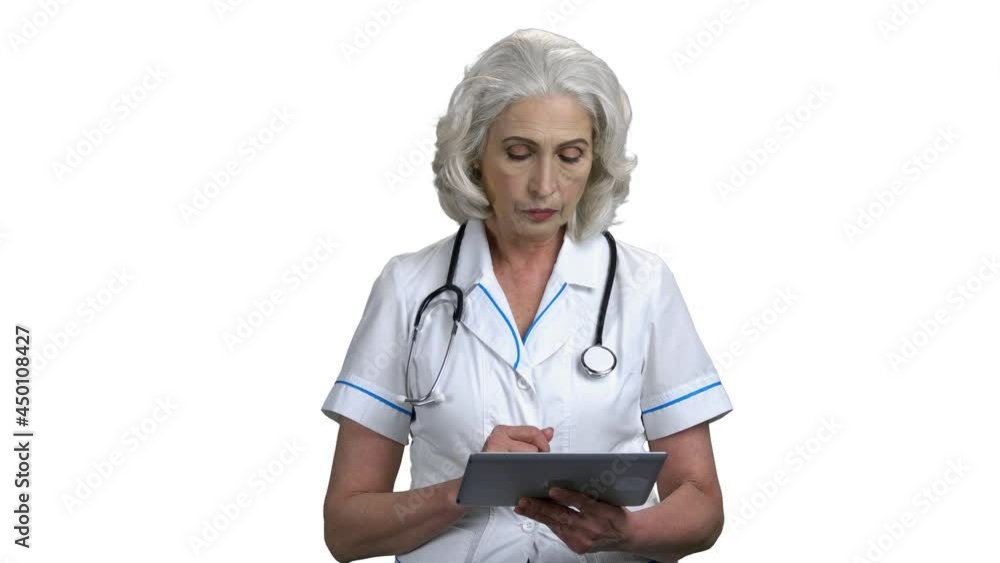 Confident female doctor working on digital tablet. Confident female doctor working on digital tablet.