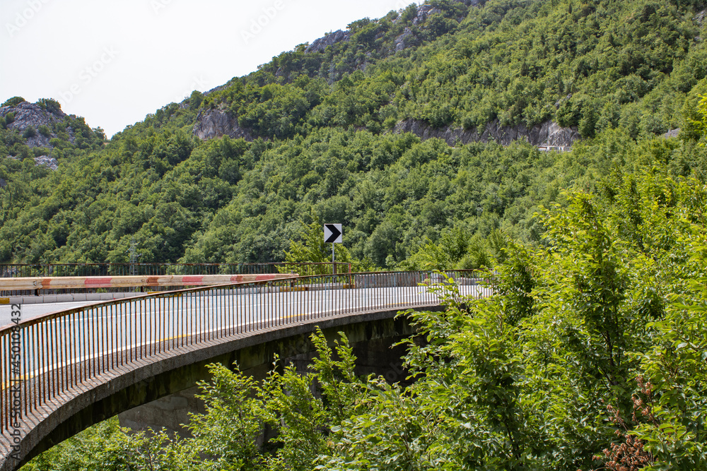 Winding and picturesque road high in the mountains. Beautiful summer landscape. Transport route and nature. Winding and picturesque road high in the mountains. Beautiful summer landscape. Transport route and nature.