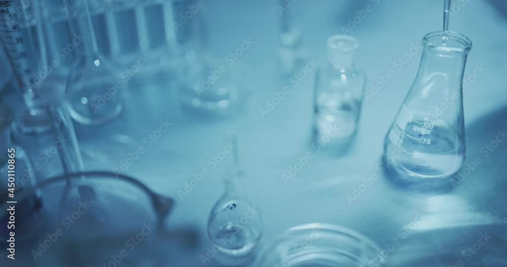 Hand of scientist holding lab glassware, science laboratory research and development concept Hand of scientist holding lab glassware, science laboratory research and development concept