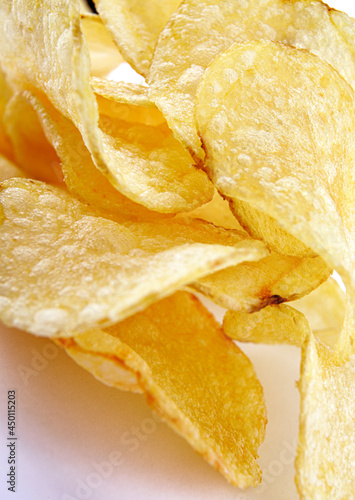 Delicious crispy potato chips on a white background.