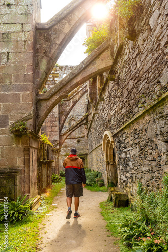 A young man visiting the interior gardens of the Abbaye de Beauport in the village of Paimpol, Côtes-d'Armor department, French Brittany. France