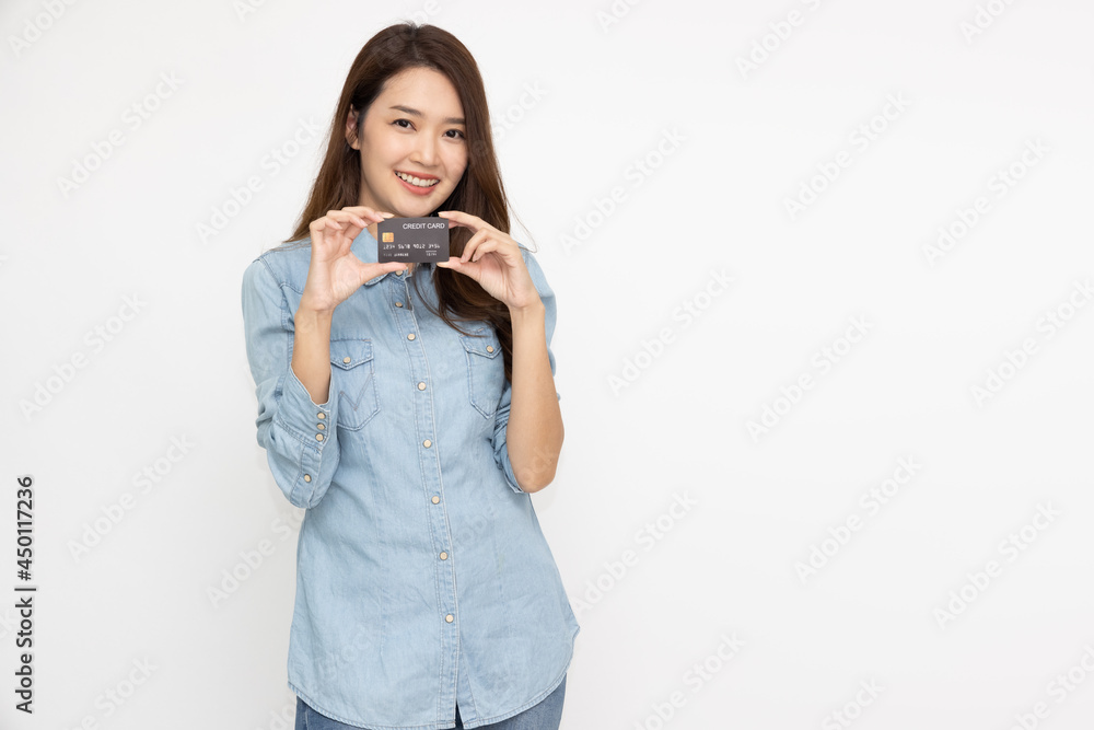 Young beautiful Asian woman smiling, showing, presenting credit card for making payment or paying online business isolated on white background Young beautiful Asian woman smiling, showing, presenting credit card for making payment or paying online business isolated on white background