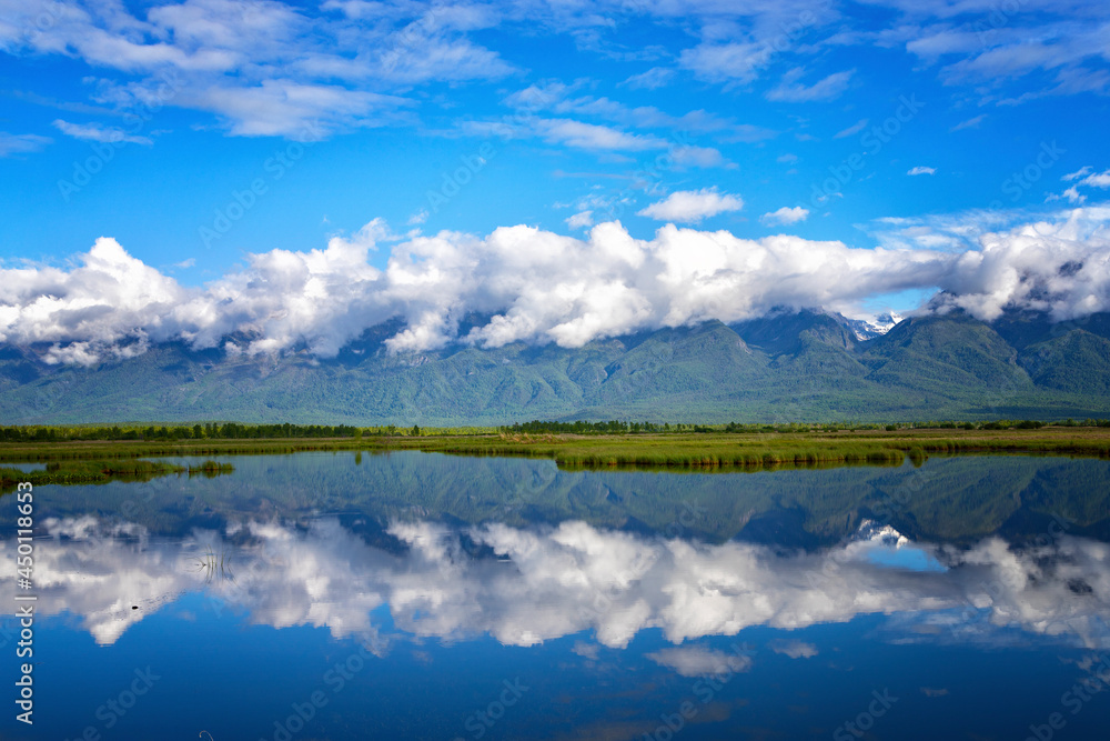 Landscape with mountains reflecting in the water. Buryatia, Tunkinskaya valley