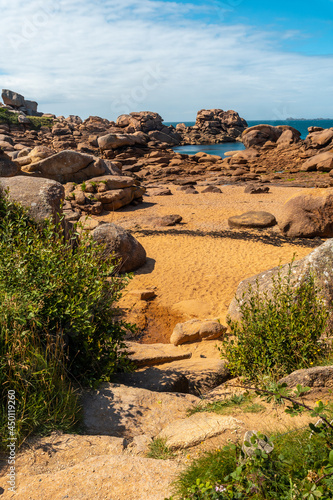 Coast at low tide along Mean Ruz lighthouse, port of Ploumanach, in the town of Perros-Guirec, Cotes-d'Armor, in French Brittany, France. photo