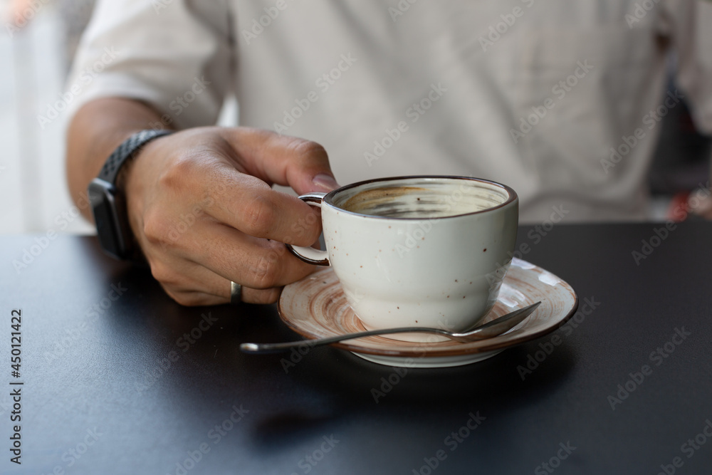 a man drinks black coffee in a summer cafe a man drinks black coffee in a summer cafe