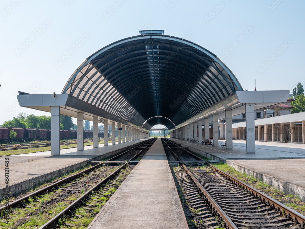 Fototapeta premium Empty train station. A platform under a glass roof.