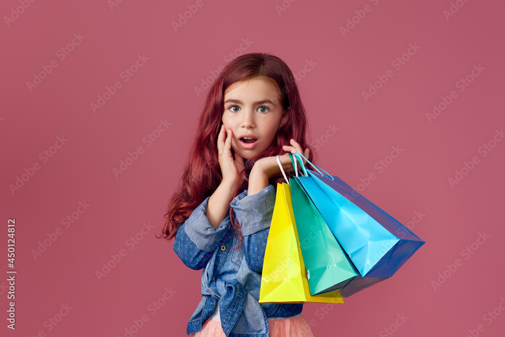 little caucasian child girl holds shopping bags little caucasian child girl holds shopping bags