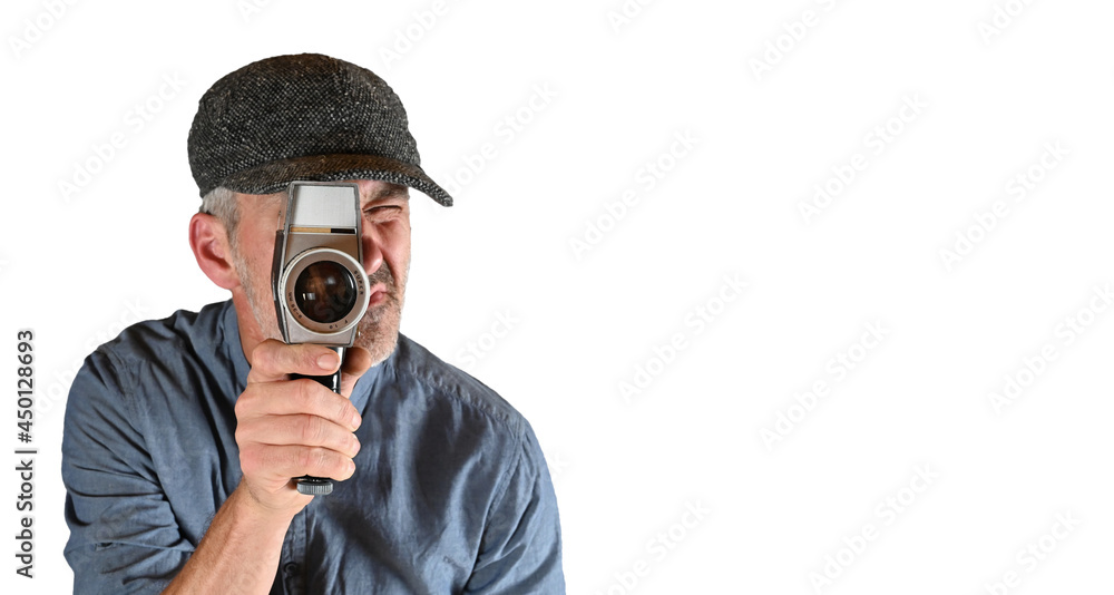 Mann mit Kappe dreht ein Film - Linse im Focus. - Kameramann Mann mit Kappe dreht ein Film - Linse im Focus. - Kameramann