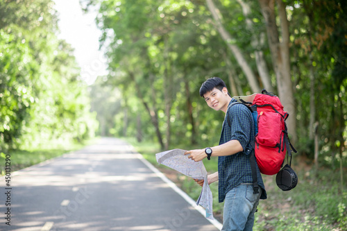 Young backpacker man looking map while working in trip © Johnstocker