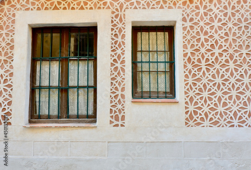 Two different windows on the wall with sgraffito finishing technique, typical in Segovia downtown district, Spain