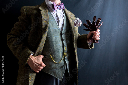 Portrait of Gentleman in Tweed Suit Powerfully Holding Leather Gloves. Vintage Style and Retro Fashion. Classic and Eccentric English Gentleman.