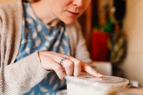 Woman checking deliver box with precooked food