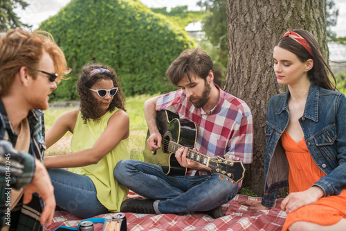 Romantic young people with guitar in nature