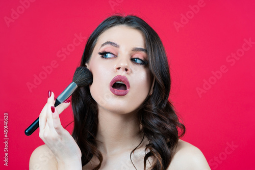 Highlight makeup. Beautiful woman applies a highlighter on her face. Conturing And Highlighting lines on sexy woman face. photo