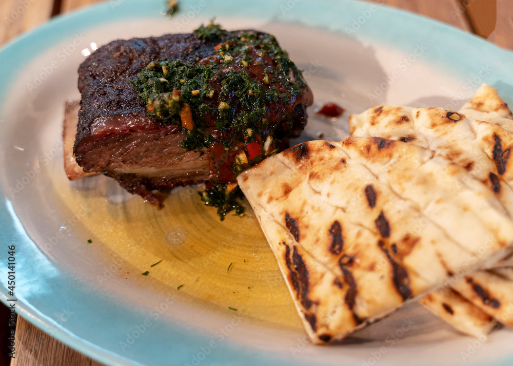 grilled ribs with pita bread, a dish from the restaurant grilled ribs with pita bread, a dish from the restaurant