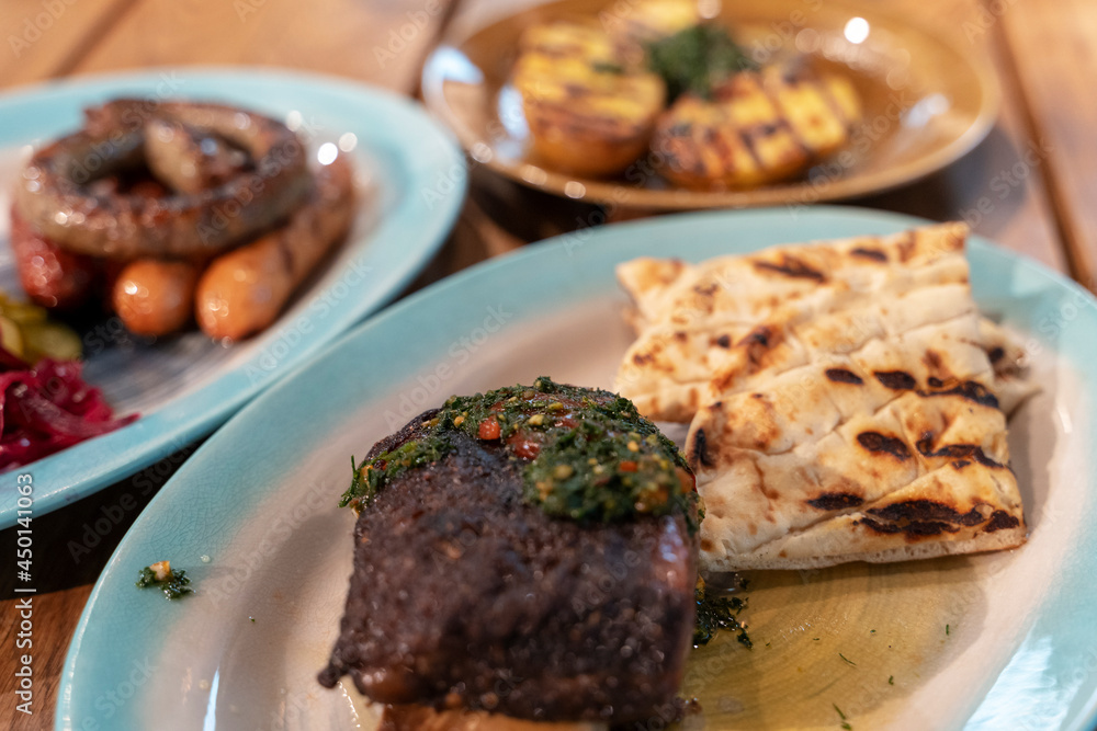 assorted dishes with potatoes, baked ribs and sausages, dishes in the restaurant