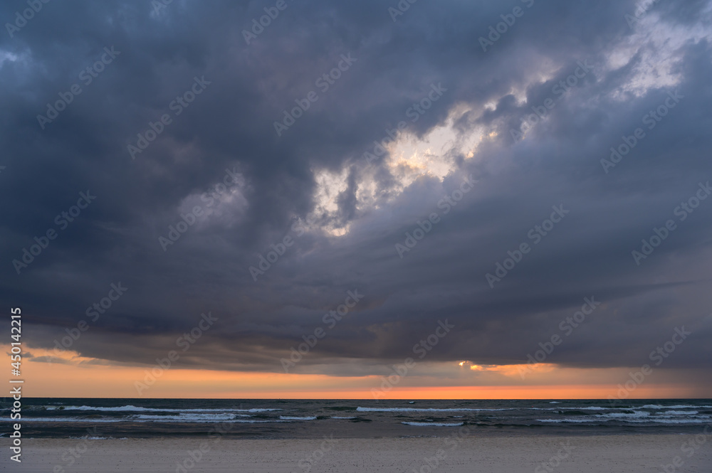 dark clouds at sunset by the sea