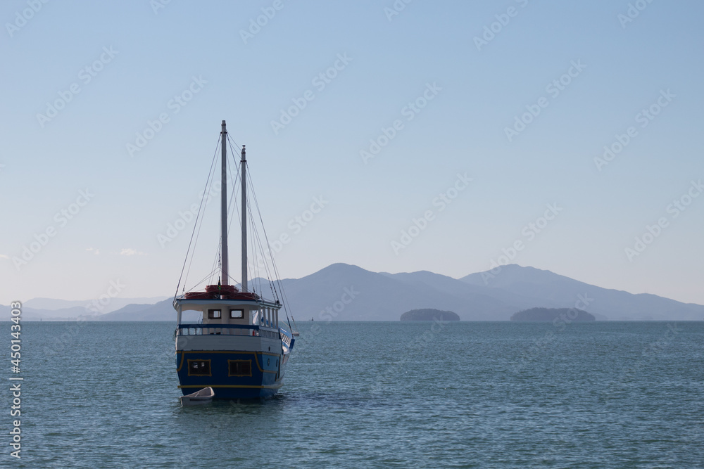 fishing boat in the background blue mountains on a sunny day in the city of Florianópolis, Brazil fishing boat in the background blue mountains on a sunny day in the city of Florianópolis, Brazil