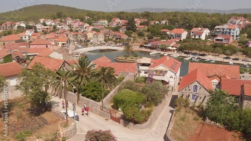 Aerial 4k video of the bay and old city with fortress and church in the town of Vrboska on Hvar island, Croatia
