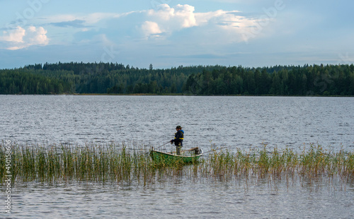 Fisherman on boat at lake
