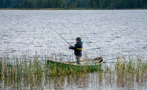 Fisherman on boat at lake