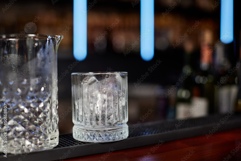 glasses with ice cubes on the wooden table glasses with ice cubes on the wooden table