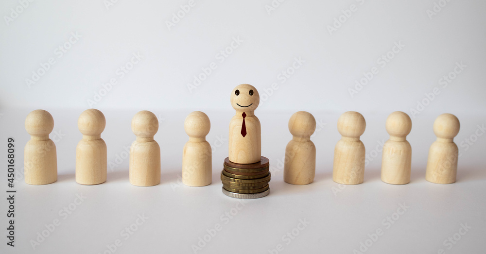 The child was lost in the crowd. A crowd of wooden figures of people surround a lost child. The child was lost in the crowd. A crowd of wooden figures of people surround a lost child.