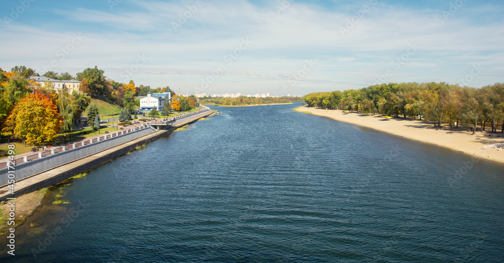 View of the Sozh River from the pedestrian bridge. Sozh river embankment. Gomel park. Autumn in the Gomel park. Belarus.