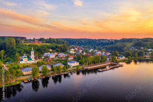 Aerial drone view of ancient russian town Ples on the Volga river with colorful sunset