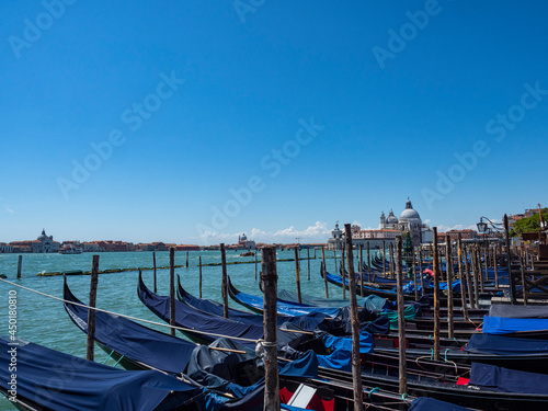 Gondolas moored in a Venice canal © Nikokvfrmoto