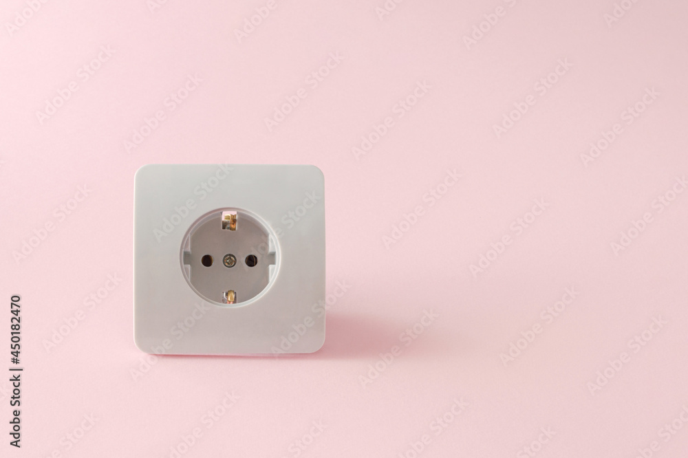 Power plug on a pink background with large copy space. Electricity concept Power plug on a pink background with large copy space. Electricity concept