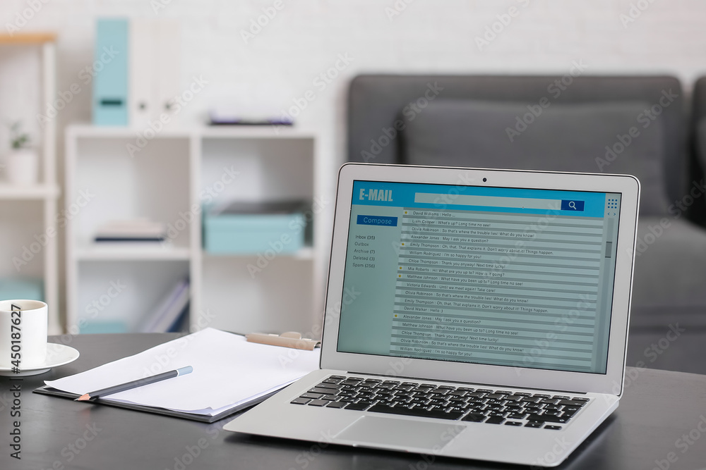 Laptop with open e-mail box on table Laptop with open e-mail box on table