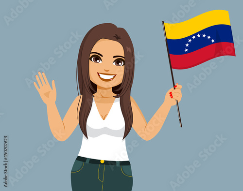 Young beautiful Venezuelan latina woman holding Venezuela Flag and waving hand