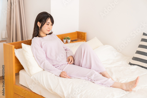 パジャマを着た女性　ベッド　笑顔 © miya227