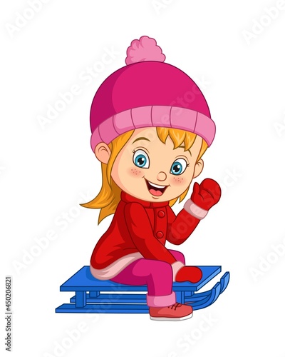 Cute little girl sledding down a hill