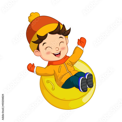 Cute little boy sledding down a hill