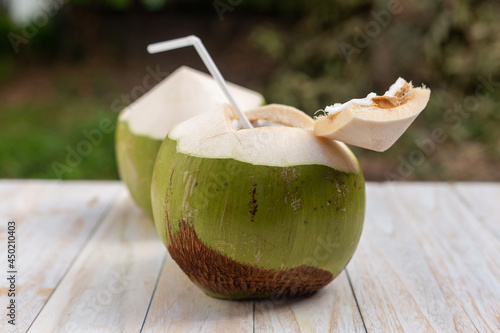 Fresh coconut ready to drink on the wooden table